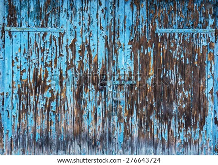 Old wooden garage gate with faded paint