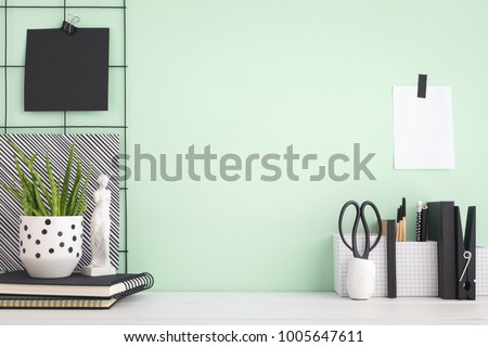 Modern home decor with figurine, stationery, books, plant. Artist workspace with copy space.