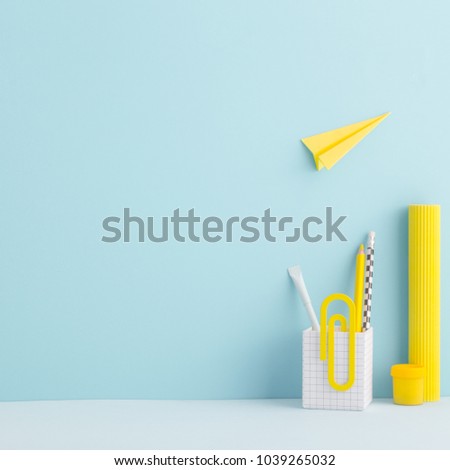 Creative desk mock up with yellow supplies and paper plane. Back to school mock uo.