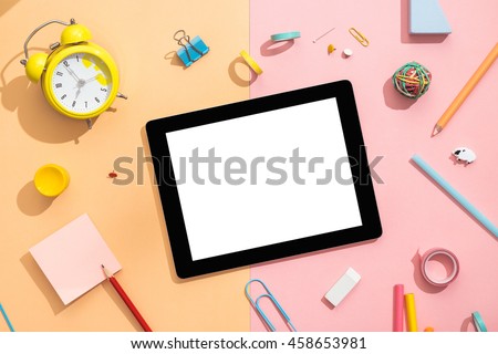 Back to school concept. Blank tablet with school and office supplies on office table. Flat lay with copy space.