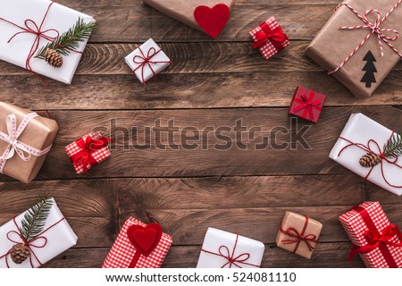Modern gifts on a wooden rustic table with copy space. Christmas background. View from above. Flat lay