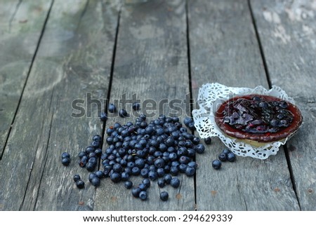 delicious juicy blueberries and cake on a white cloth laid on antique grey wooden floor
