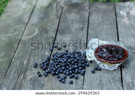 delicious juicy blueberries and cake on a white cloth laid on antique grey wooden floor