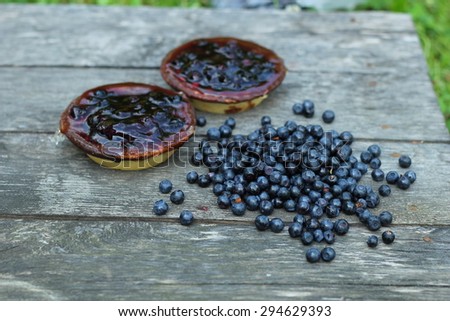 delicious juicy blueberries and cake laid on antique grey wooden floor