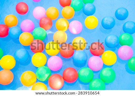 colored balls floating in kiddie pool