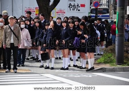 10 April, 2012. Tokyo, Japan.\
Japanese girl students waiting at the crossroad
