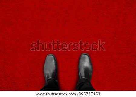 black shoes standing on red carpet floor - begin his success and fame