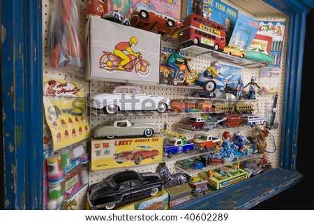 Toy shop window full of tin plate and other retro toys and games.