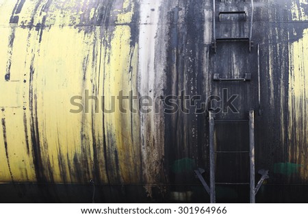 Railroad train of black tanker cars transporting crude oil on the tracks.