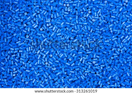 blue color plastic granulate in glancing light for background / plastic material