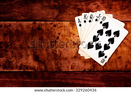 royal straight flush card over wooden texture background dark tone style / winner,lucky,success