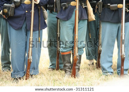Yankee Soldiers Stand at Attention in Well Worn Uniforms with Official Issued Muskets, Civil War Belt Buckles and Leather Ammo Bags.
