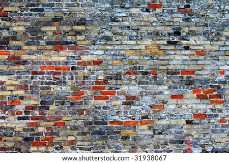 Multi Color Century Old Brick Wall With Much Chipping.  Quite Shabby Chic Grunge Looking for Texture or Background