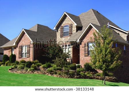 Stately nicely landscaped upscale brick home somewhere in the midwest USA.