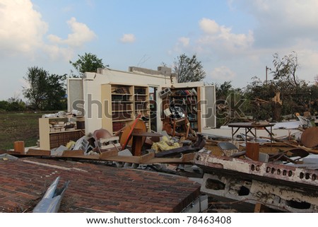 The power of nature\'s fury, as well as it\'s perplexity, is displayed in this image of books still on their shelves while the building that housed them succumbed to 200+ mph winds of a EF5 tornado.