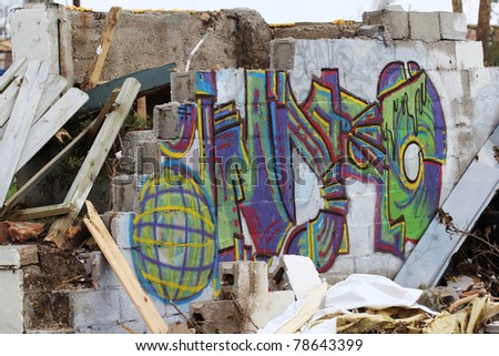 JOPLIN, MO - MAY 22: colorful graffiti stands out on this broken wall after a deadly EF-5 tornado tore through Joplin tearing down nearly every man made object in it\'s path. Joplin, MO, May 22, 2011