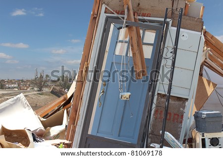 A damaged blue front door is all that is left after an EF5 tornado paid a visit to this home in Joplin, Missouri in May of 2011.