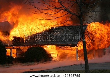 A blazing house fire engulfs a porch.  Fire is one of the most destructive forces of nature, killing thousands each year and leaving nothing but ashes in it\'s wake