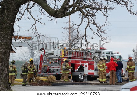 TONTITOWN, AR - FEB. 4: Firemen in full gear gather around a firetruck to receive instructions during a control burn exercise on February 4, 2012 in Tontitown, AR.  The exercise was open to the public.