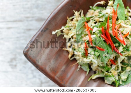 Urap, an Indonesian-style salad, served with herbs and red chillies.