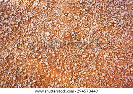 Section of local road, Red gravel texture background