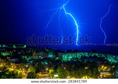 Lightning flashed near the bridge over the river