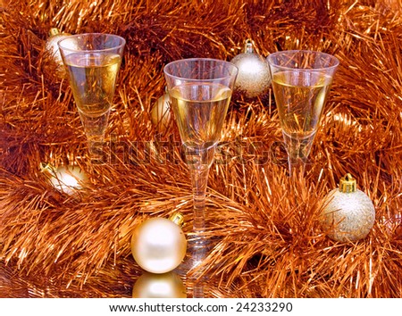 three glasses and Christmas balls are on the mirror