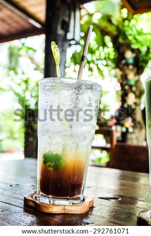 lemon tea soda and soft light background and located in a dark hall and strong sunlight at noon