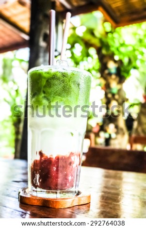 ice greentea red beans and soft light background and located in a dark hall and strong sunlight at noon