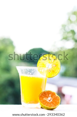 orange juice and soft light back ground and strong sunlight at noon