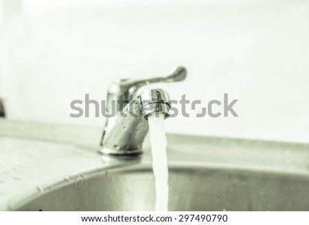 water and faucet water is isolated and strong dark light  room with sunlight at noon