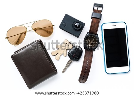 Top view of man set: watches,camera,wallet,car keys, sunglasses,and smartphone on white background; Travel set