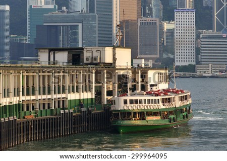 HONG KONG - JULY 15, 2015.  Ferry Solar Star arriving to Kowloon pier. The Star Ferry\'s ferry is an important part of the commuter system between Hong Kong Island and Kowloon.