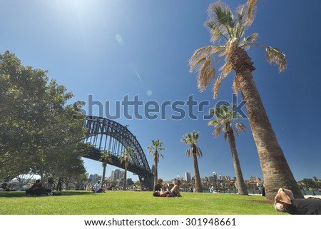 SYDNEY, AUSTRALIA - NOVEMBER 02, 2014: Residents and visitors relaxing on the quayside with the Harbour Bridge in the background. Sydney on November 02, 2014