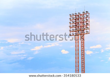 Lighting tower of stadium on sky and cloud background.