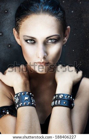 Fashion portrait of pretty young girl in heavy metal style