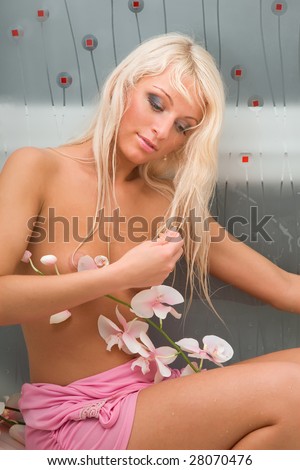 stock photo Beautiful naked blonde girl in pink with a flower