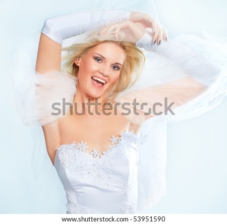Portrait of happy young bride with veil isolated on white