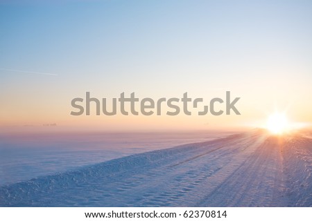 Perspective of winter road on sunset