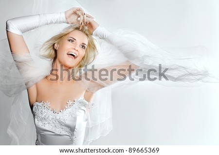 Portrait of happy young bride with bridal veil
