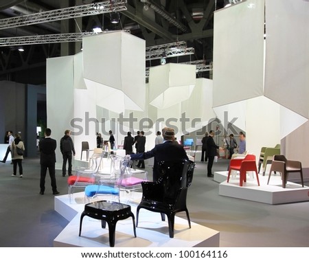 MILAN - APRIL 13: People look at interiors design and home architecture solutions during Salone del Mobile, international furnishing accessories exhibition on April 13, 2011 in Milan, Italy.