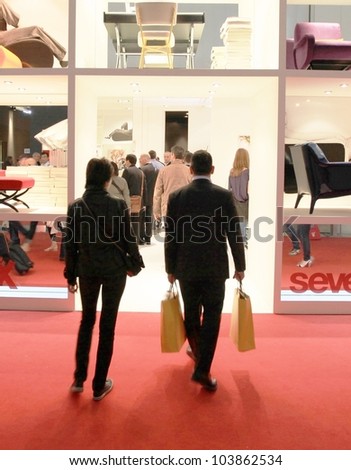 MILAN - APRIL 13: People look at interior design solutions during Salone del Mobile, international furnishing accessories exhibition on April 13, 2011 in Milan, Italy.