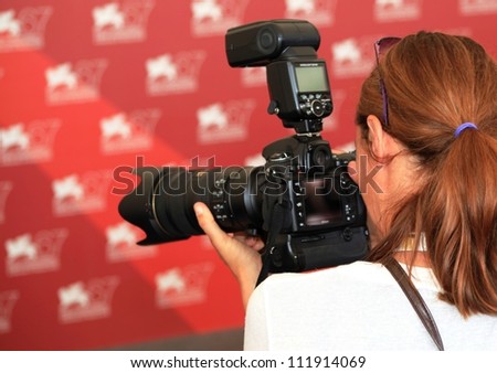 VENICE, ITALY - SEPTEMBER 03: A photographer waits for stars on the red carpet at 67th Venice Film Festival September 03, 2010 in Venice, Italy.
