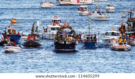 PLAYA BLANCA, LANZAROTE - JULY 22: People on the boats with the Vergin del Carmen statue during the annual holy procession July 22, 2007 in Playa Blanca, Lanzarote.