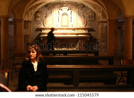 MANTOVA, ITALY - MARCH 21: A woman praying at Crypt under St. Andrew cathedral just before Jesus Christ holy blood relic annual exposition March 21, 2008 in Mantova, Italy.