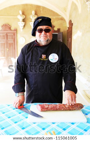 MANTOVA, ITALY - JUNE 13: A chef ready to offer local salami during Golosaria, fair show of food and gastronomy culture June 13, 2010 in Mantova, Italy.