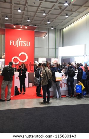 MILAN, ITALY - OCTOBER 17: People visit Fujitsu technologies products area at SMAU, international fair of business intelligence and information technology October 17, 2012 in Milan, Italy.