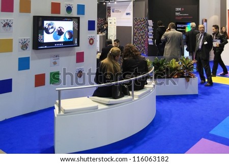 MILAN, ITALY - OCTOBER 17: People visit IBM technology products exhibition area at SMAU, international fair of business intelligence and information technology October 17, 2012 in Milan, Italy.