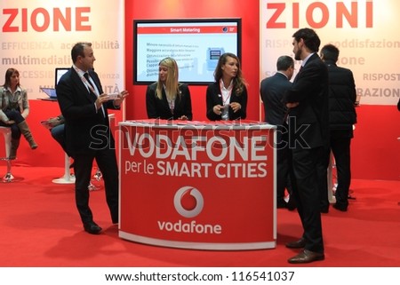 MILAN, ITALY - OCTOBER 17: People visit Vodafone technology products exhibition area at SMAU, international fair of business intelligence and information technology October 17, 2012 in Milan, Italy.
