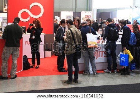 MILAN, ITALY - OCTOBER 17: People visit Fujitsu technology products exhibition area at SMAU, international fair of business intelligence and information technology October 17, 2012 in Milan, Italy.